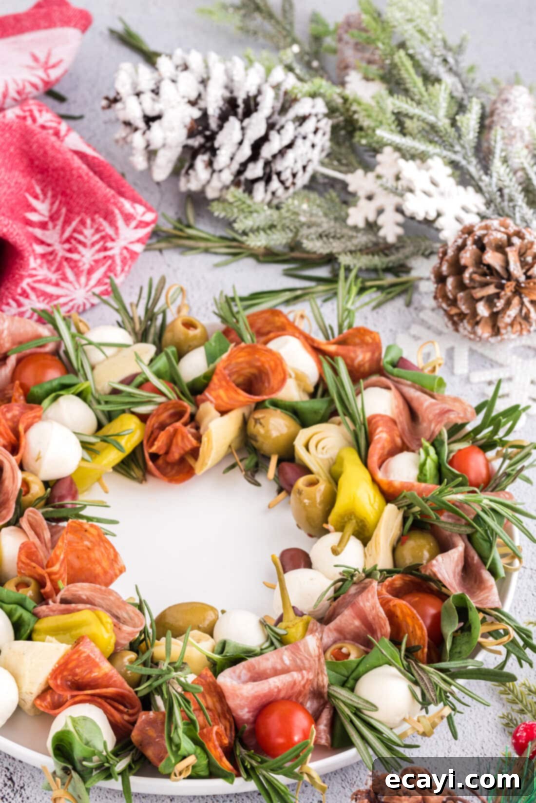 Gourmet Grazing Wreath 3 A festive Antipasto Wreath elegantly displayed on a table amidst holiday decorations.