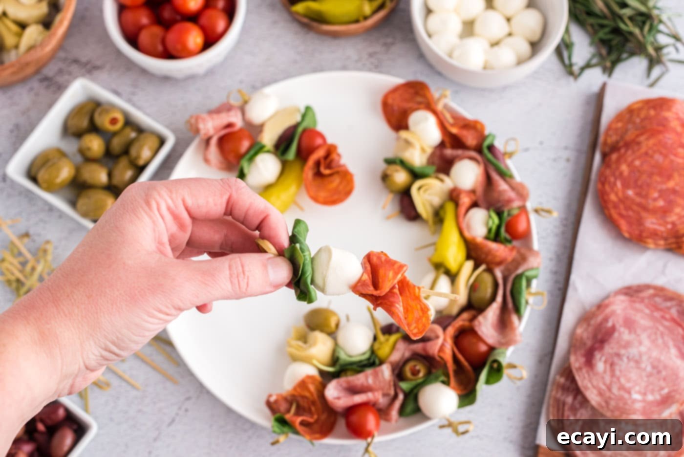 Gourmet Grazing Wreath 6 Another antipasto skewer showcasing basil, a mozzarella ball, and a piece of prosciutto, illustrating diverse ingredient combinations.
