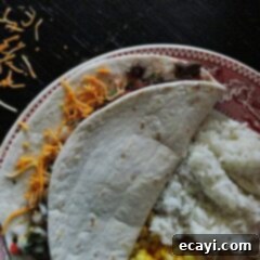 Tender Steak Soft Tacos 2 An overhead photo of a steak soft taco resting on a plate.