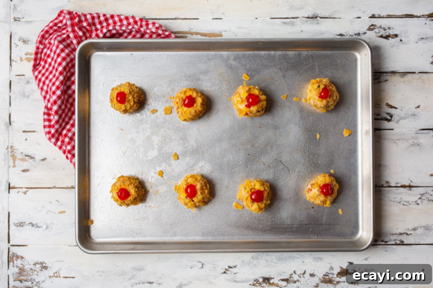 Ruby Cherry Gems 11 cherry wink cookie dough balls on a baking sheet