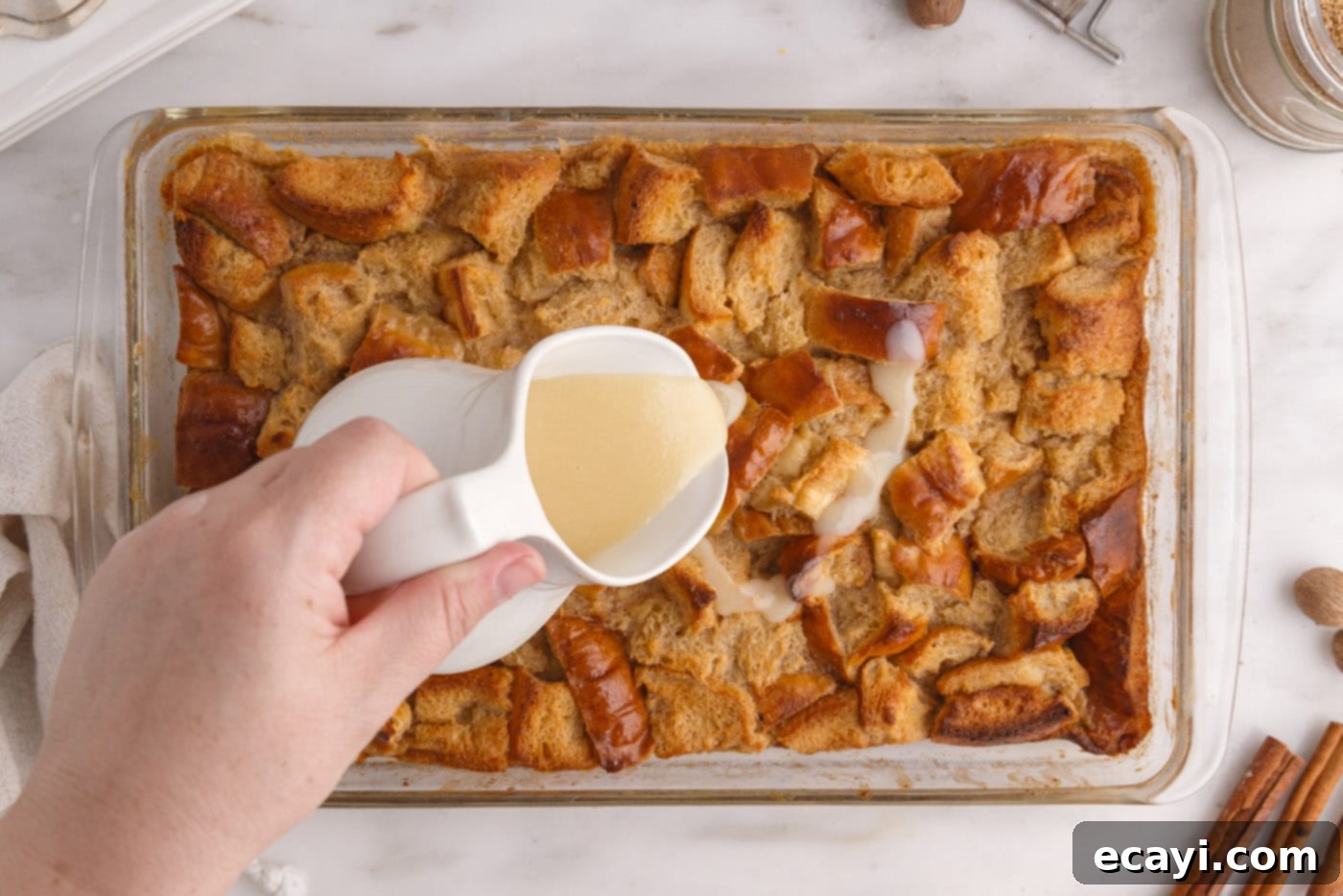 Homemade Bread Pudding Perfection 14 pouring vanilla sauce over bread pudding