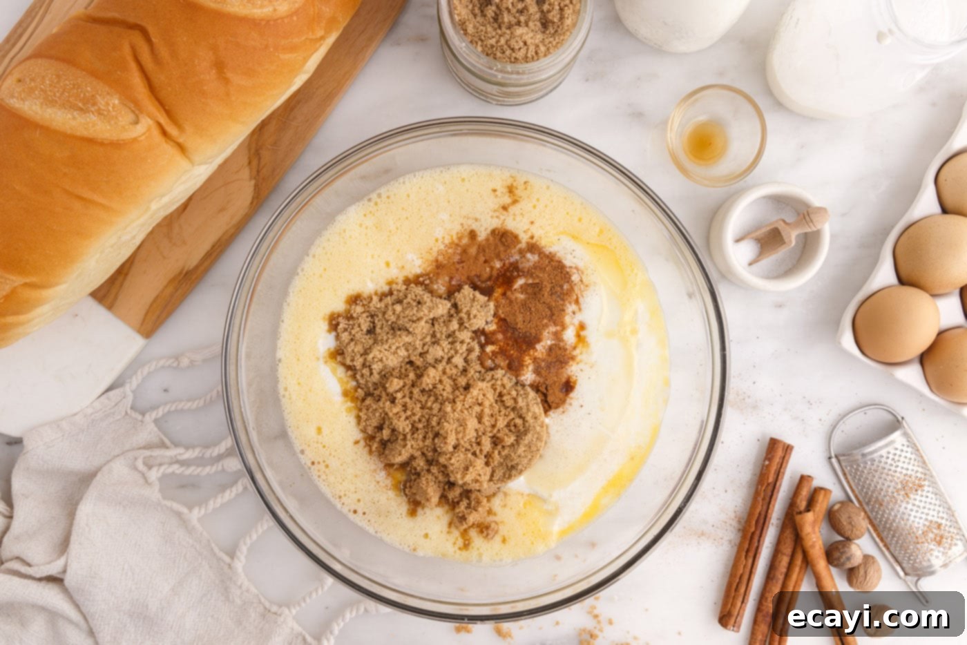 Homemade Bread Pudding Perfection 6 eggs, brown sugar, spices, and buttermilk in a mixing bowl