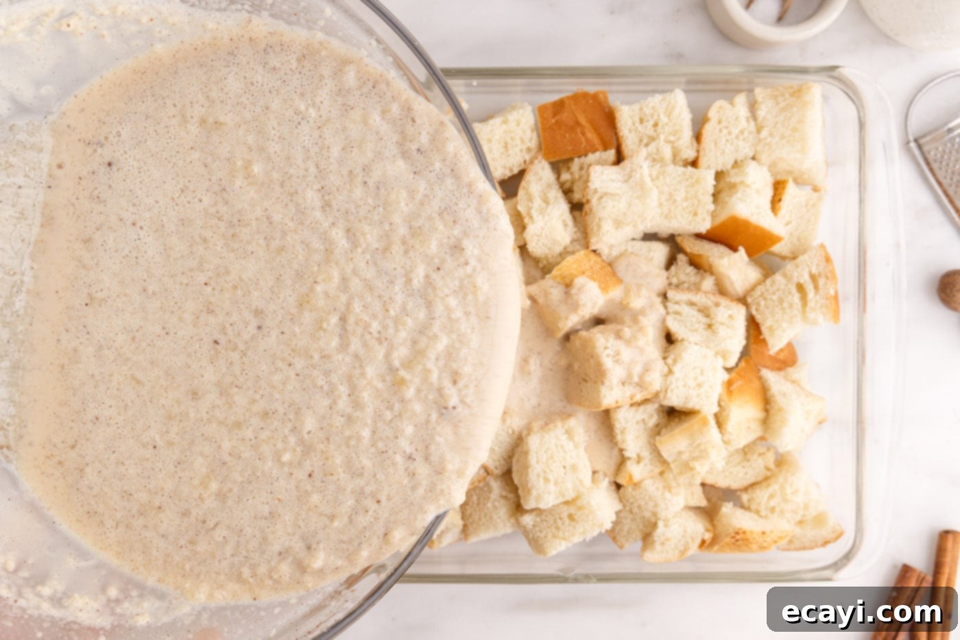 Homemade Bread Pudding Perfection 8 pouring cream mixture over bread cubes in a baking dish