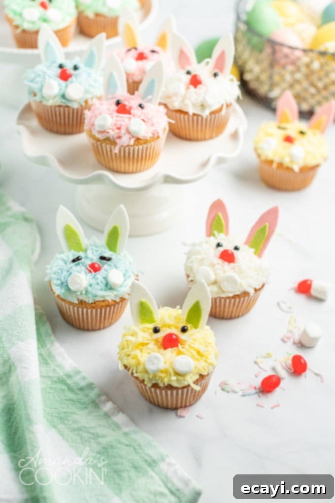 Boxed cake mix, canned frosting, flaked coconut, and fun decorations make these darling Easter Bunny Cupcake an easy and impressive dessert for the holiday. A vibrant display of decorated Easter bunny cupcakes, featuring different colored coconut fur, gum ears, marshmallow paws, and jelly bean noses.
