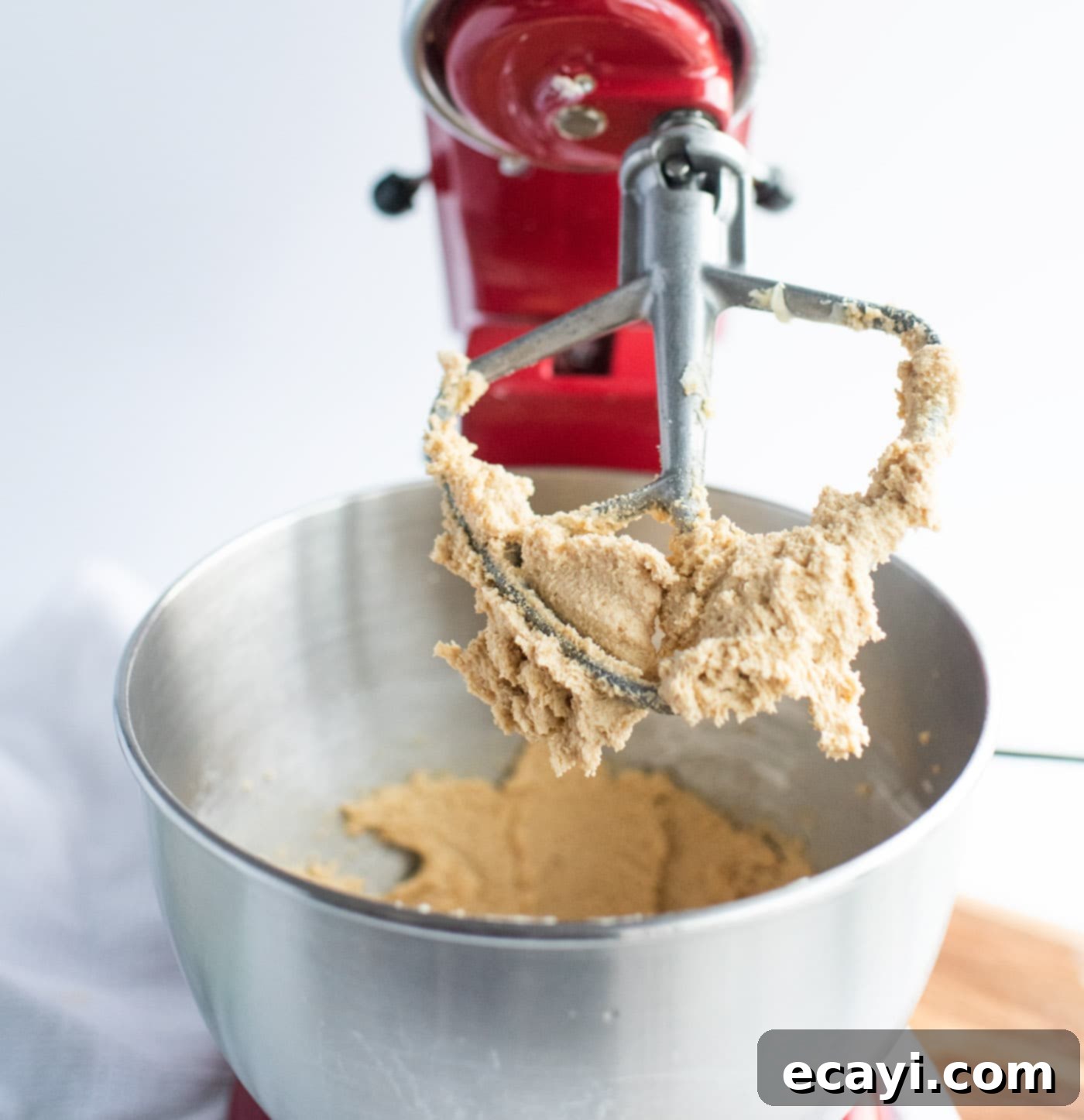 Ultimate Reese's Pieces Cookies 6 peanut butter cookie dough on paddle attachment in a stand mixer