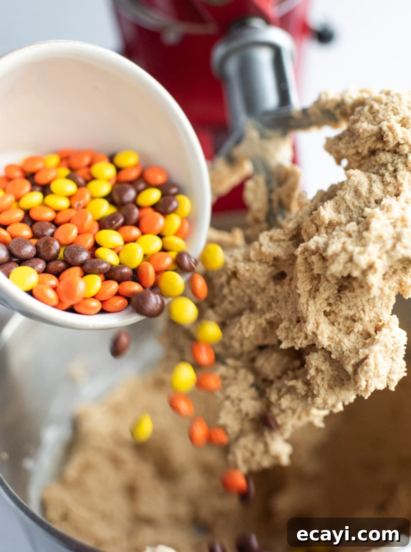 Ultimate Reese's Pieces Cookies 7 pouring Reese's pieces into cookie dough