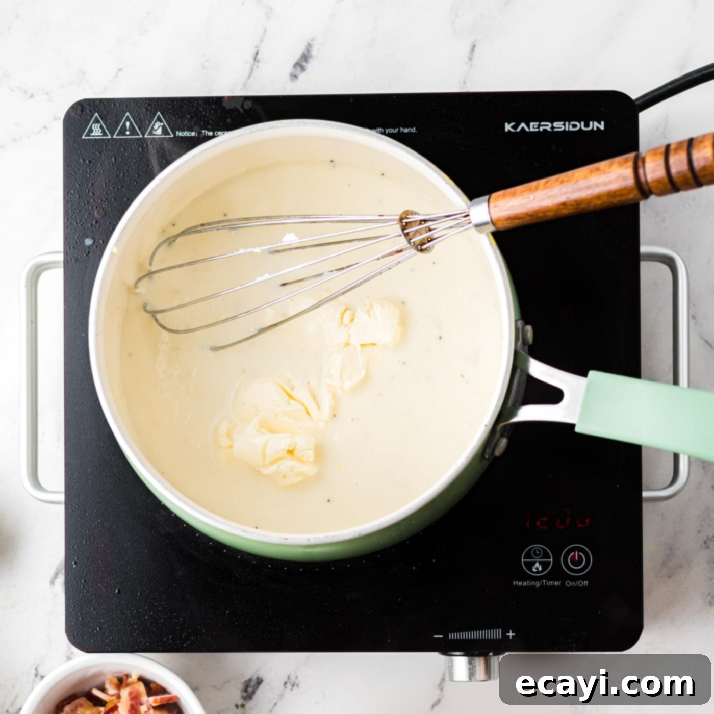 Golden Cauliflower Bake 6 stirring cream cheese into saucepan