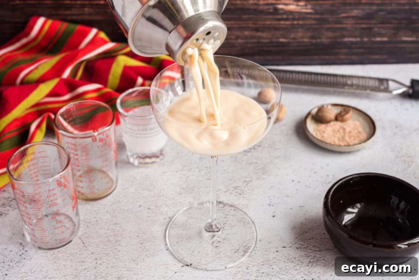 Velvet Cocoa Indulgence 8 The process of straining the chilled Brandy Alexander mixture into a martini glass.