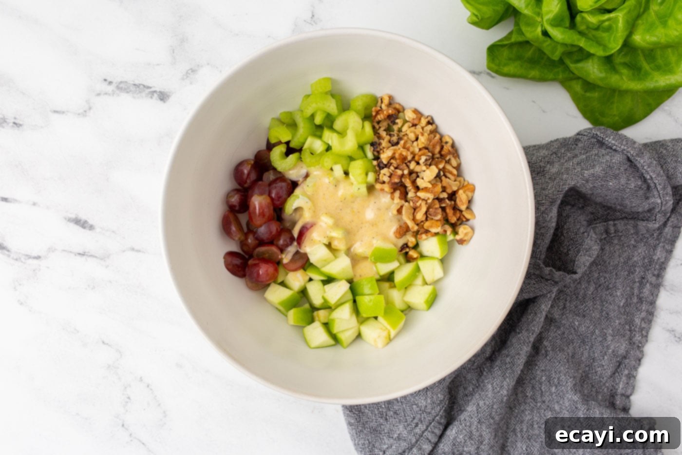 Crisp Apple Walnut Delight 6 Waldorf Salad fully mixed with its creamy dressing in a large bowl, showing a perfect coating.