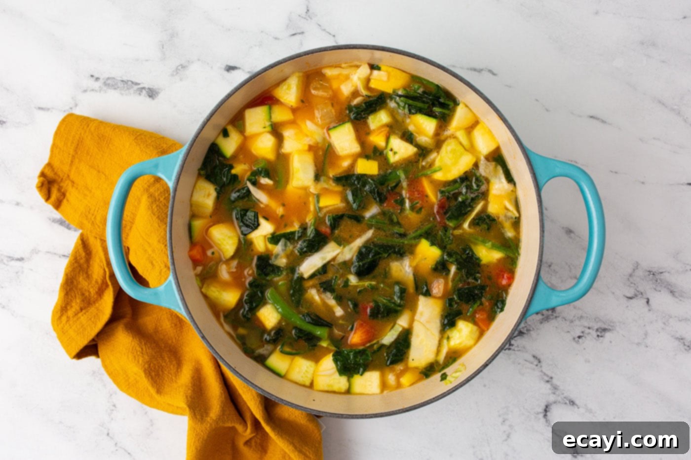Rustic Italian Minestrone 7 Minestrone soup simmering in a stockpot with added spinach, stock, salt, and pepper