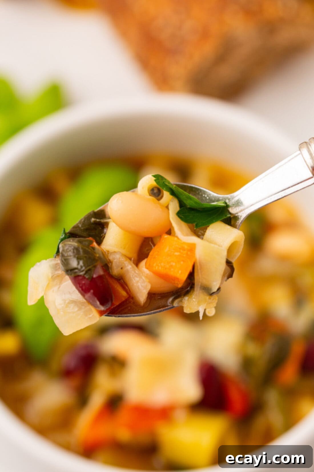 Rustic Italian Minestrone 9 Close-up of a spoon scooping a portion of rich minestrone soup, highlighting the medley of ingredients