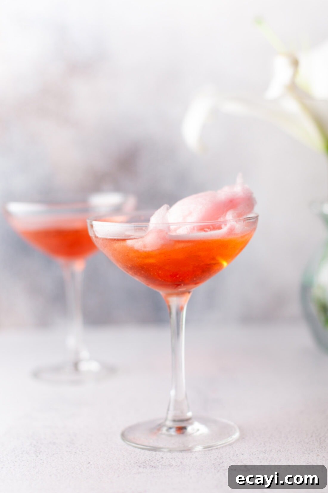 Whimsical Effervescence 3 cotton candy champagne in a martini glass, garnished and ready to serve