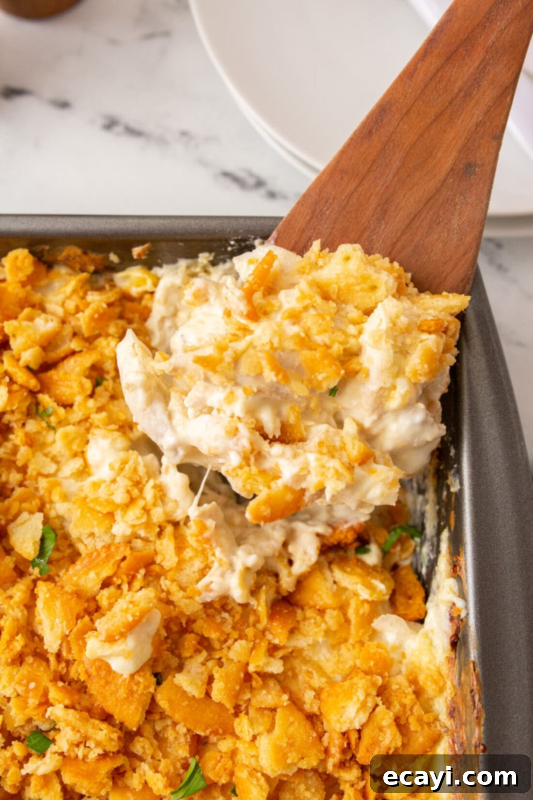Golden Chicken Casserole 2 spooning out Million Dollar Chicken Casserole