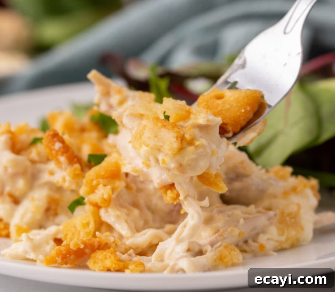 Golden Chicken Casserole 3 fork full of Million Dollar Chicken Casserole