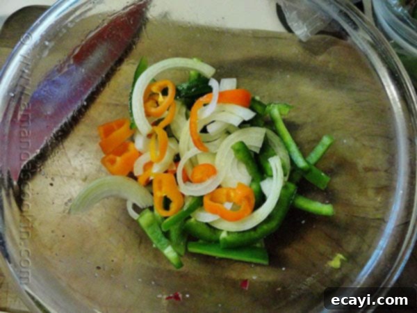 Radish Hash Browns Sliced bell pepper, sweet peppers and onions in a clear bowl.