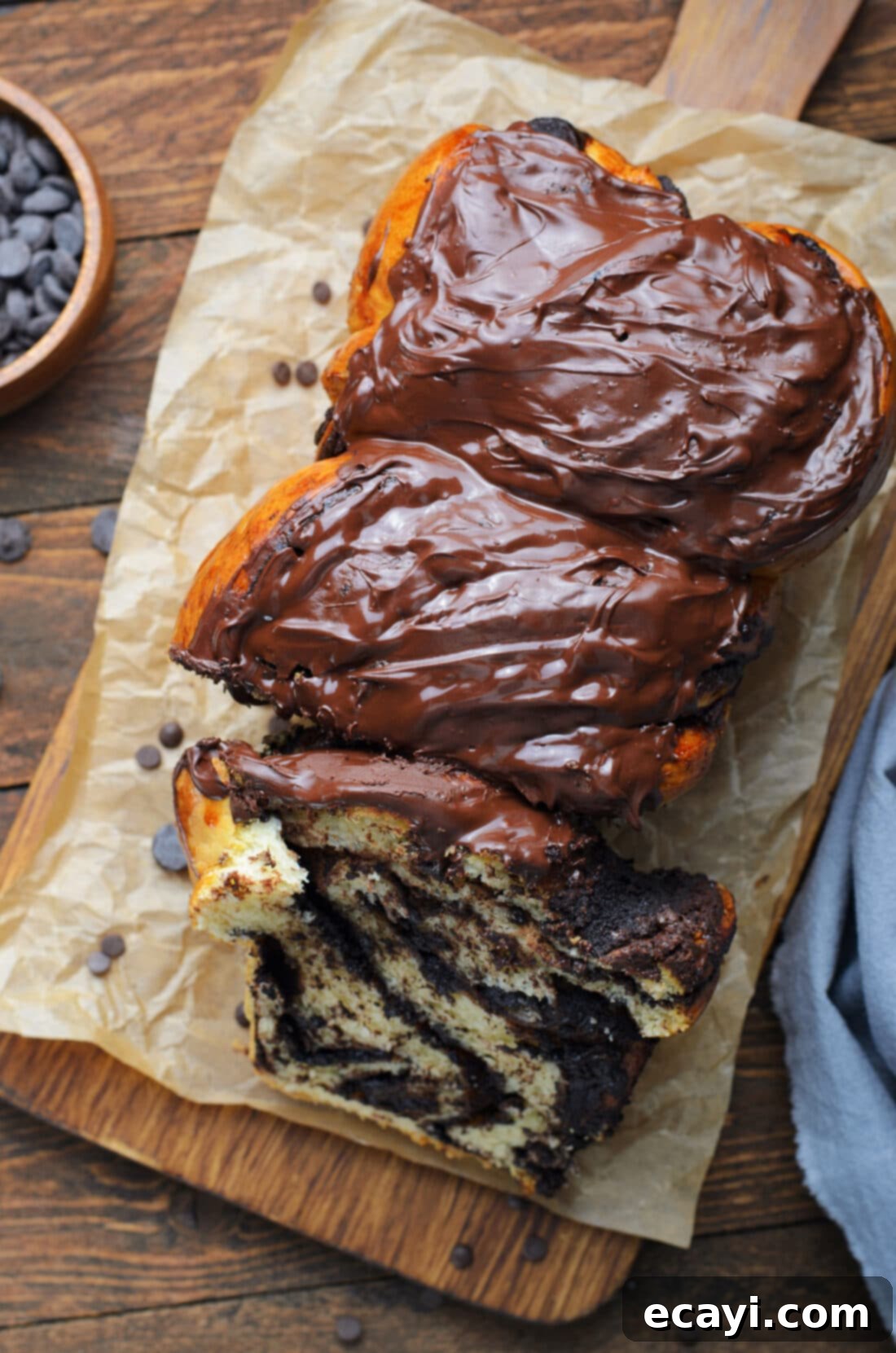 Swirling Chocolate Delight 2 Overhead view of a perfectly baked, glazed chocolate babka, showcasing its beautiful swirls and rich brown color, ready to be served.