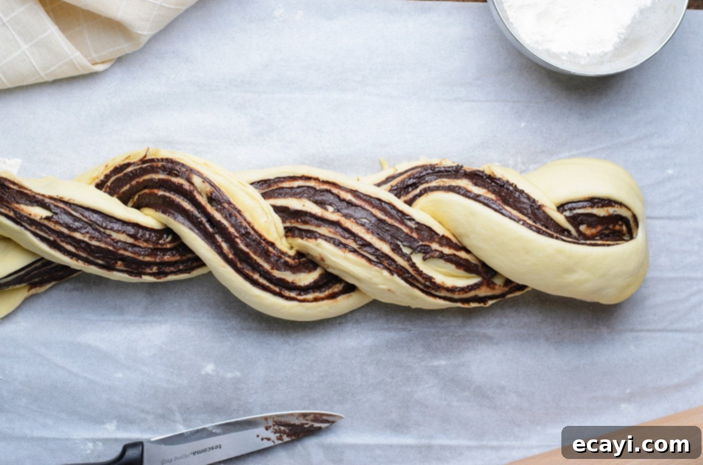 Swirling Chocolate Delight 14 The art of braiding chocolate babka dough: two halves expertly twisted together to form a stunning loaf.