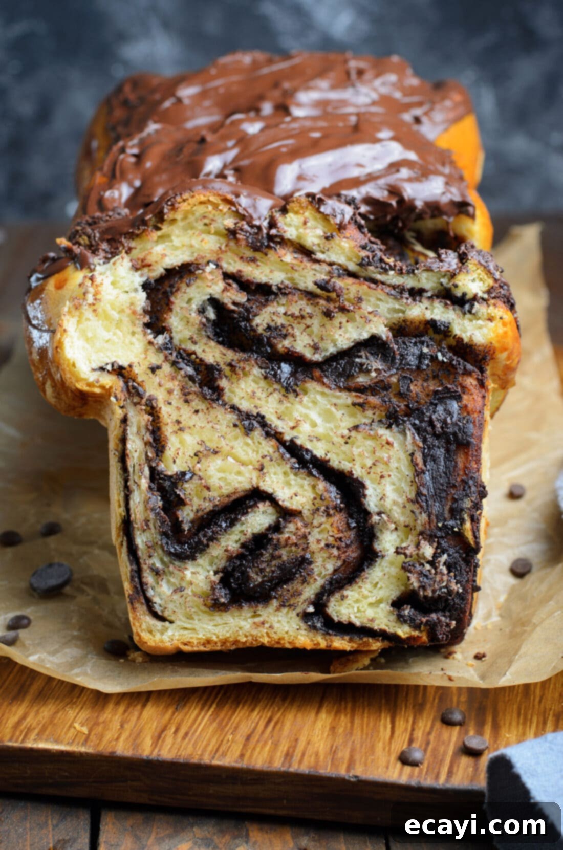 Swirling Chocolate Delight 3 Close-up photo of a beautifully sliced chocolate babka, showcasing the intricate layers of chocolate filling and fluffy, golden-brown bread.