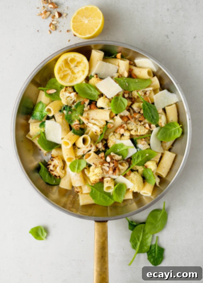 Lemon Roasted Cauliflower Pasta 6 A serving of Lemony Broiled Cauliflower Pasta, garnished with fresh herbs and toasted almonds.