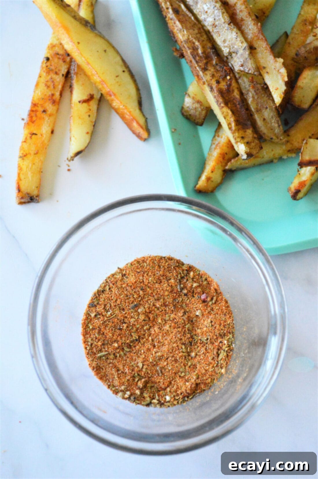 Golden Fry Seasoning 3 A collection of spices and seasonings in separate small bowls, showcasing the fresh ingredients needed for homemade French fry seasoning.
