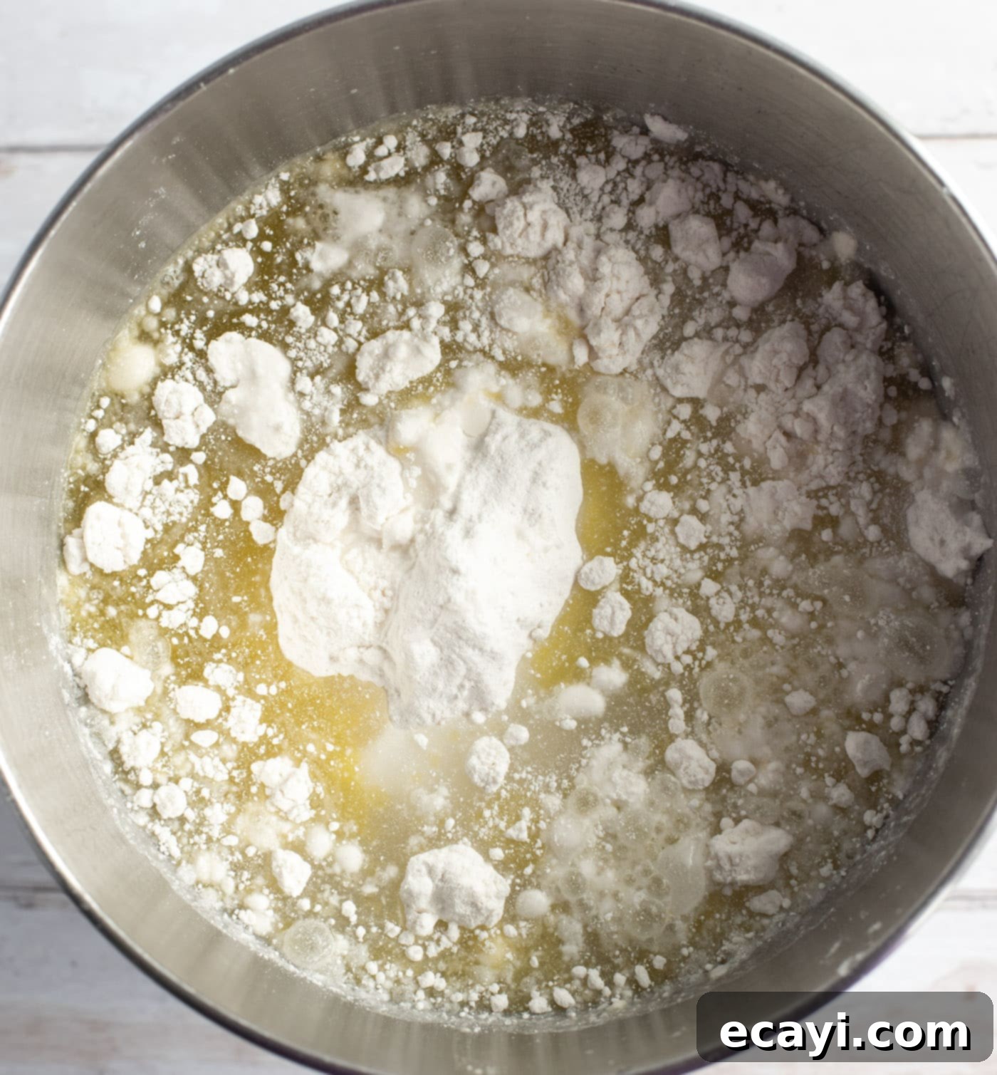 Enchanted Rainbow Bundt 6 Cake mix being prepared with oil and eggs in a mixing bowl.