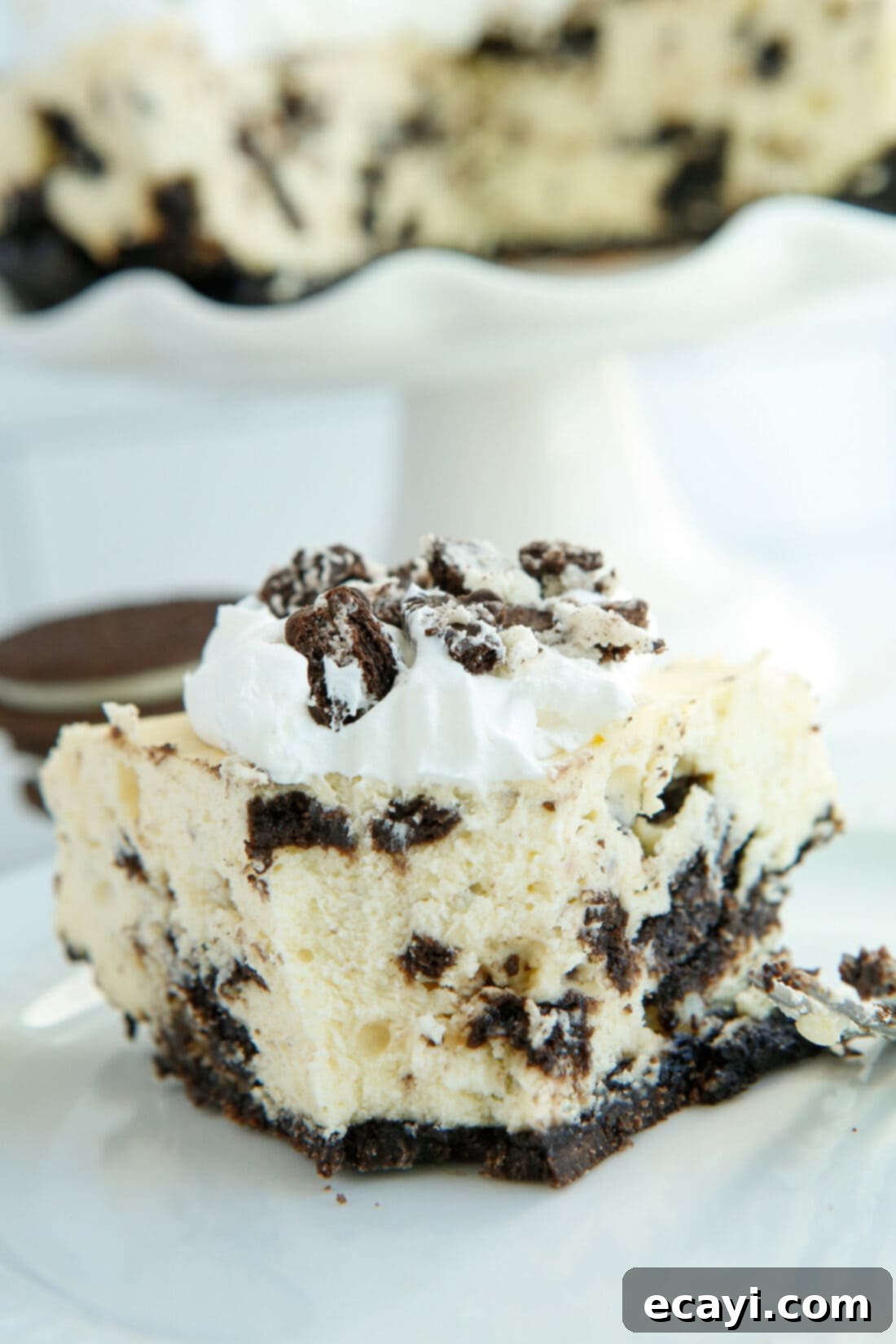 Instant Pot Oreo Cheesecake 2 slice of Instant Pot Oreo Cheesecake with bite out of it