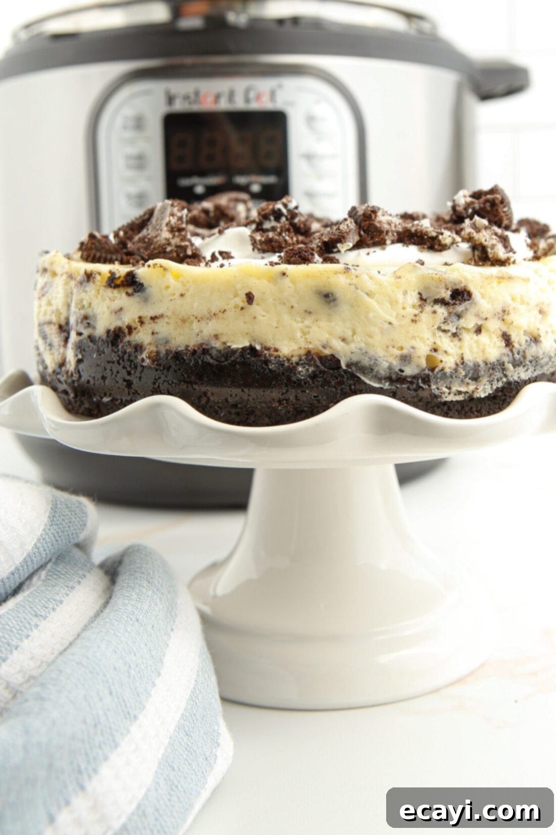 Instant Pot Oreo Cheesecake 3 Instant Pot Oreo Cheesecake on a cake plate with IP in background