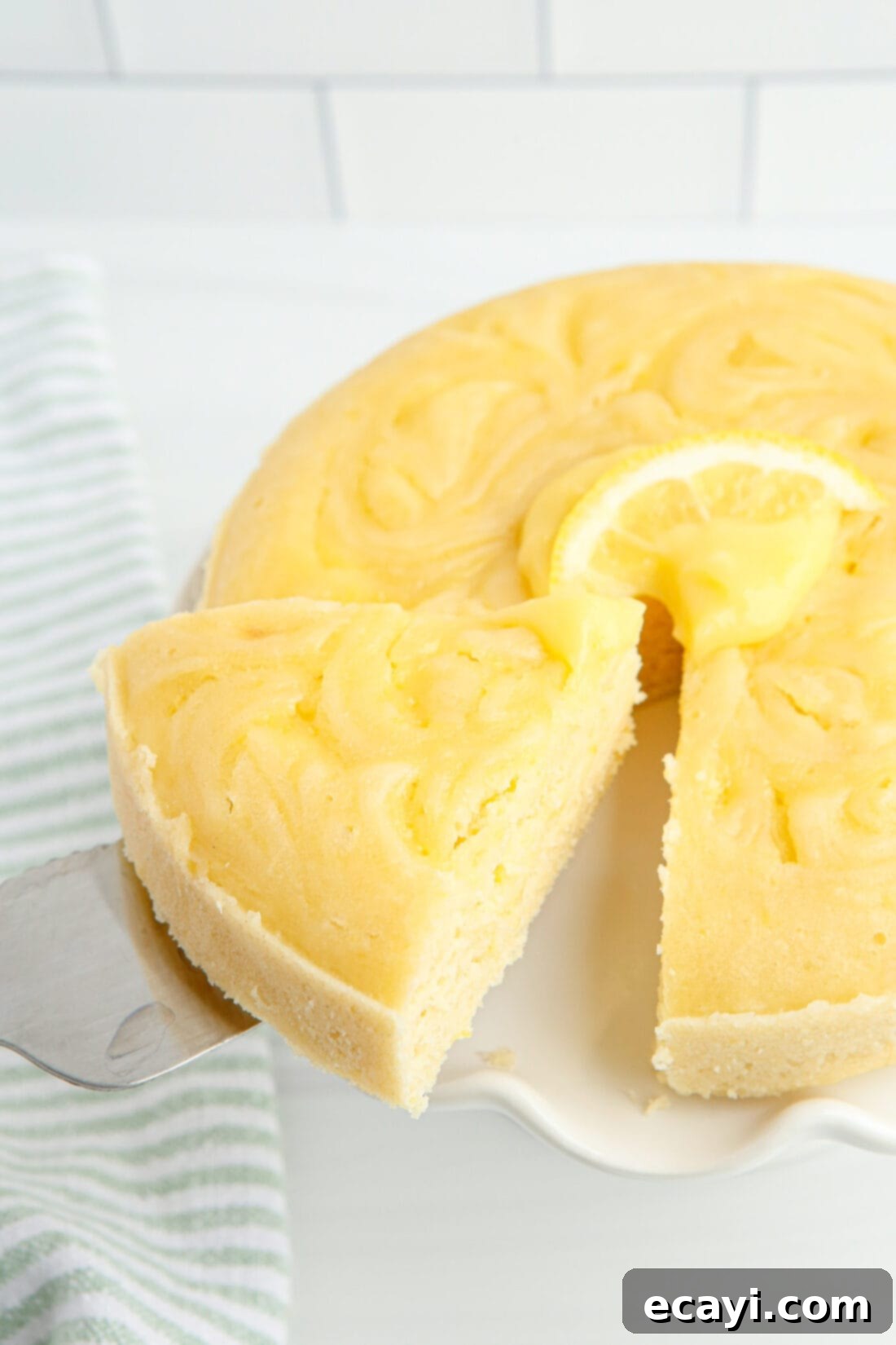 Zesty Instant Pot Lemon Cake 2 removing a slice of Instant Pot Lemon Cake