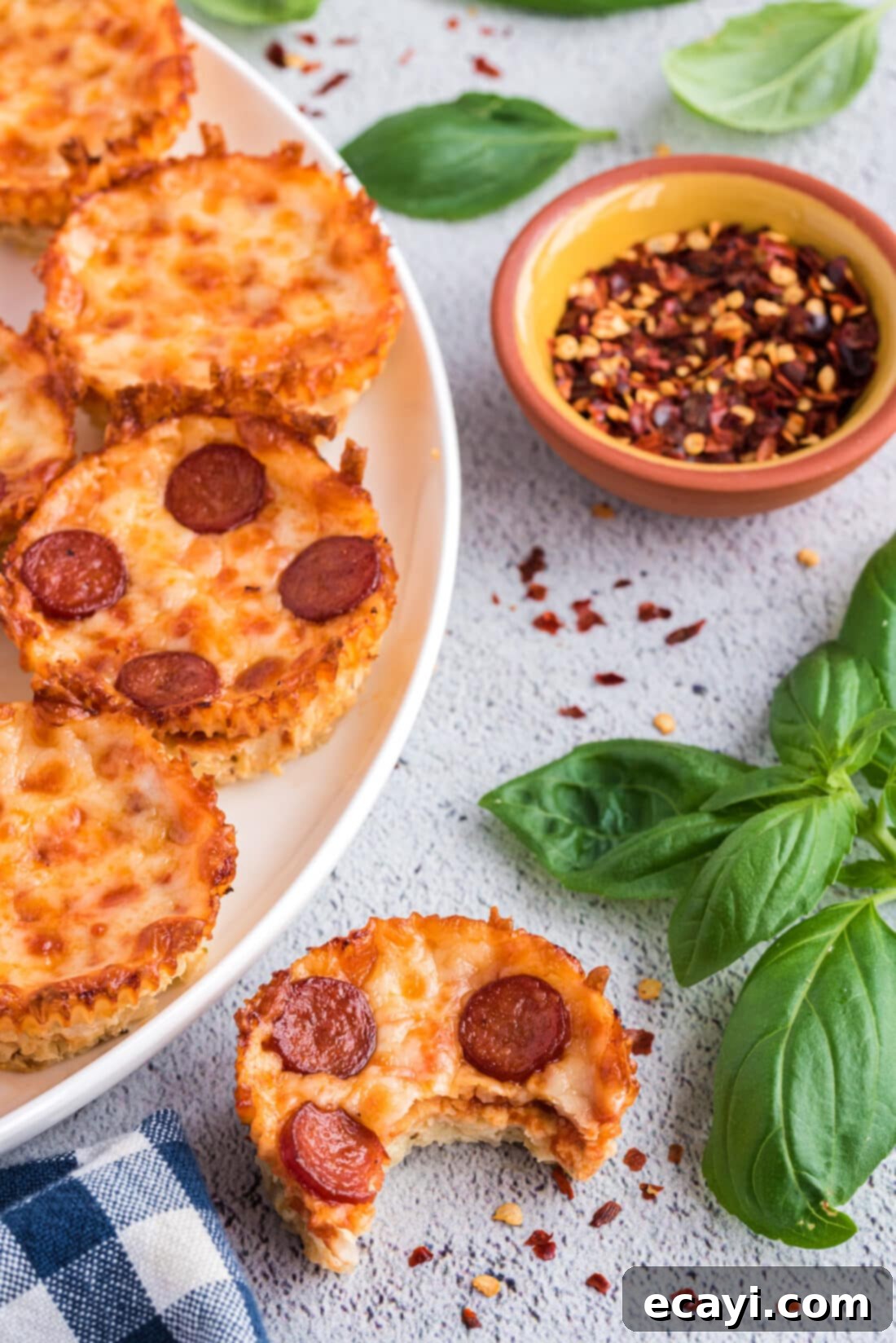 Cauliflower Crust Pizza Bites 30 Cauliflower Pizza Bites on a plate, garnished with fresh basil