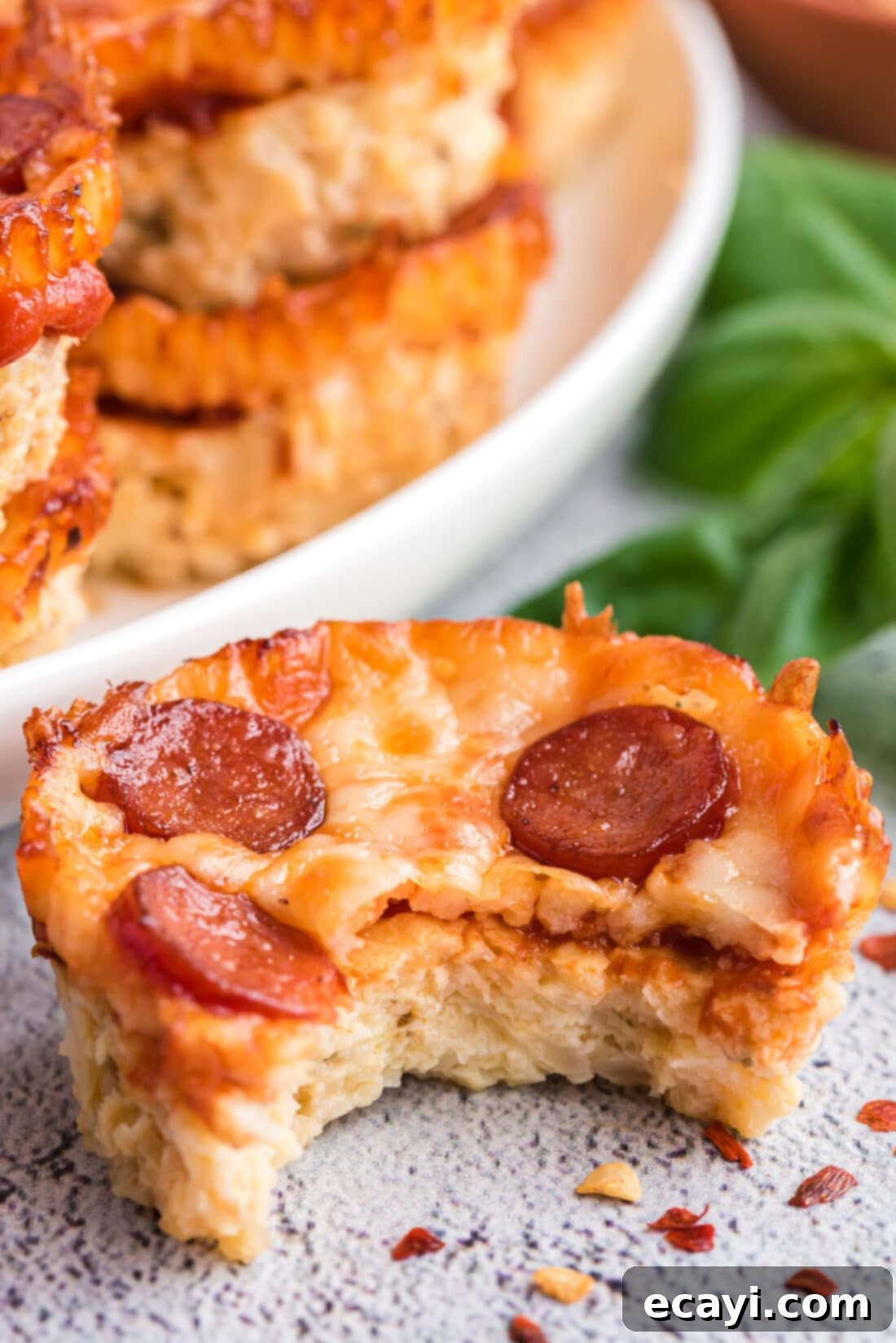 Cauliflower Crust Pizza Bites 11 close up of a Cauliflower Pizza Bite, showing melted cheese and pepperoni