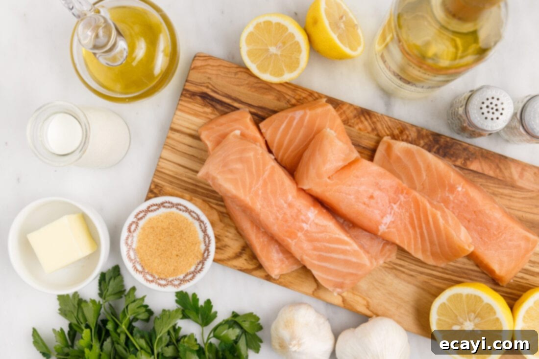 Oven Roasted Salmon Perfection 4 Close-up of fresh ingredients laid out for baked salmon, including salmon fillets, lemons, garlic, butter, and herbs