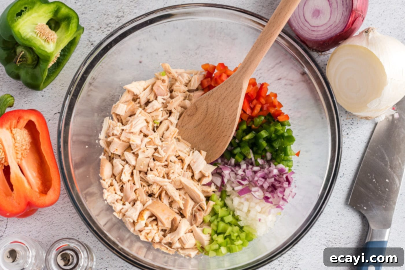 Bayou Chicken Salad 6 A large mixing bowl filled with the colorful combination of chopped chicken, diced celery, red bell pepper, green bell pepper, and onions, waiting for the dressing.