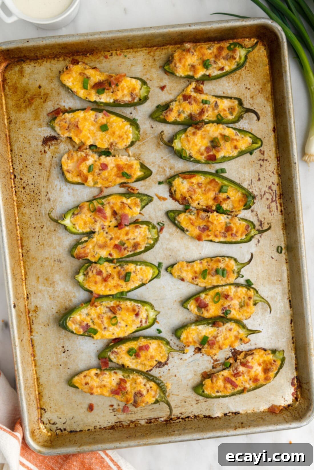 Golden Jalapeño Delights 3 Freshly baked Jalapeño Poppers arranged neatly on a sheet pan