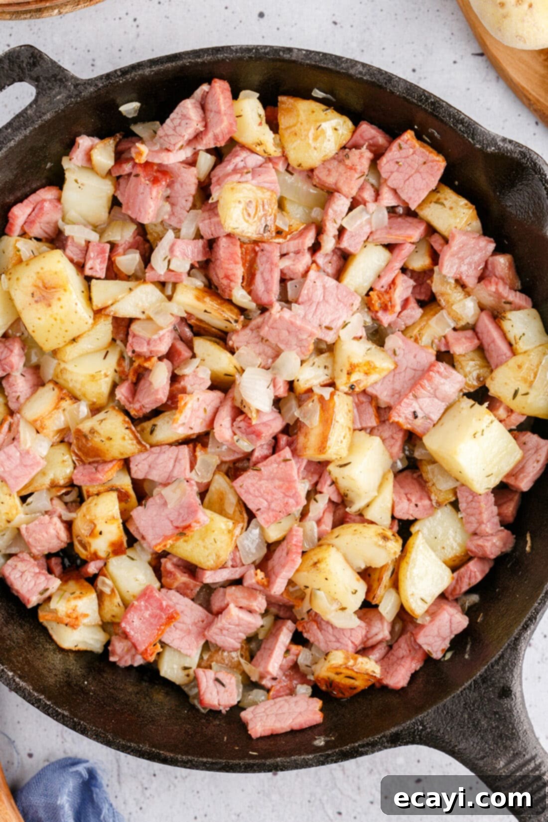 Crispy Corned Beef Hash 2 Delicious Corned Beef Hash sizzling in a cast iron skillet, ready to be served