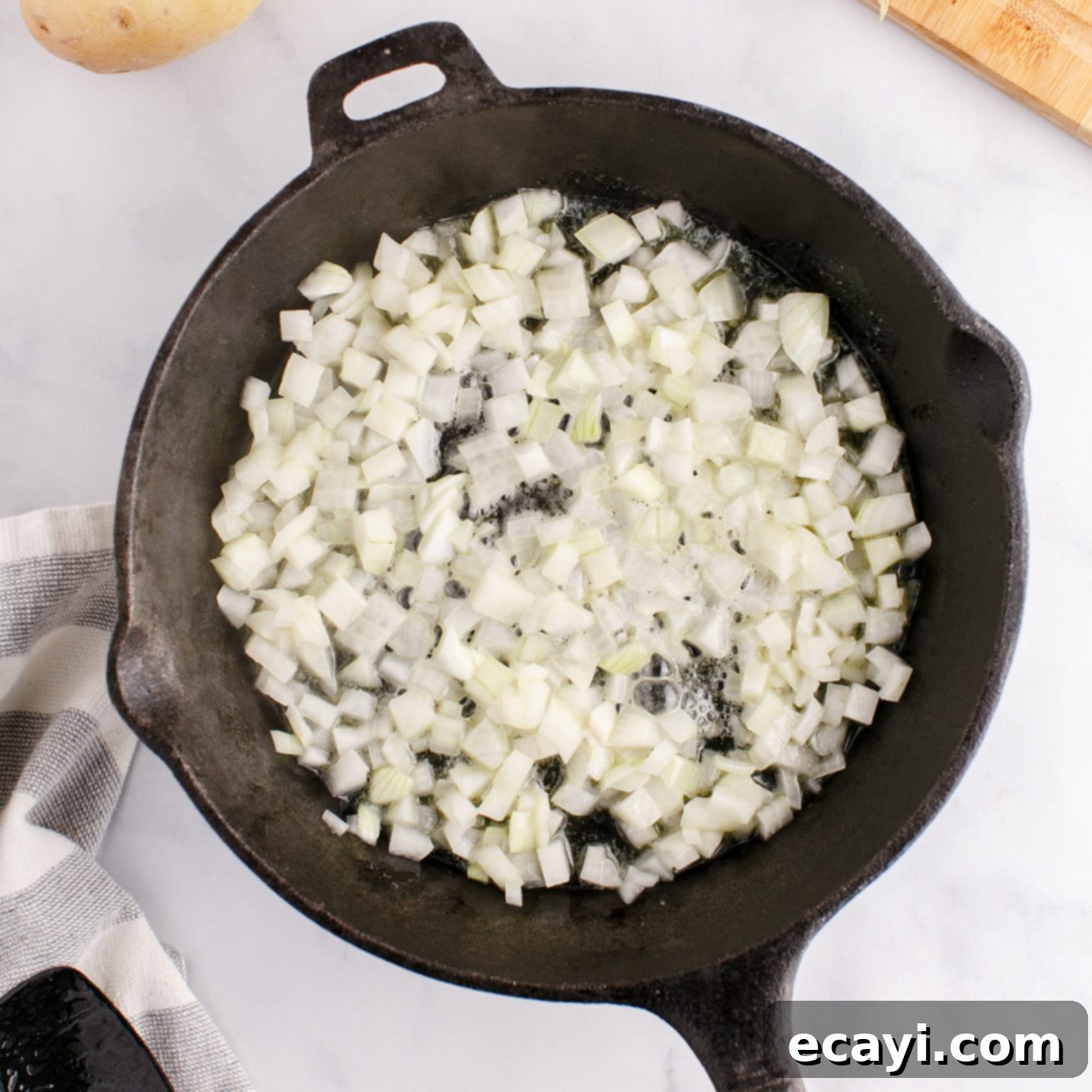Crispy Corned Beef Hash 7 Finely chopped onions sizzling in melted butter in a cast iron skillet