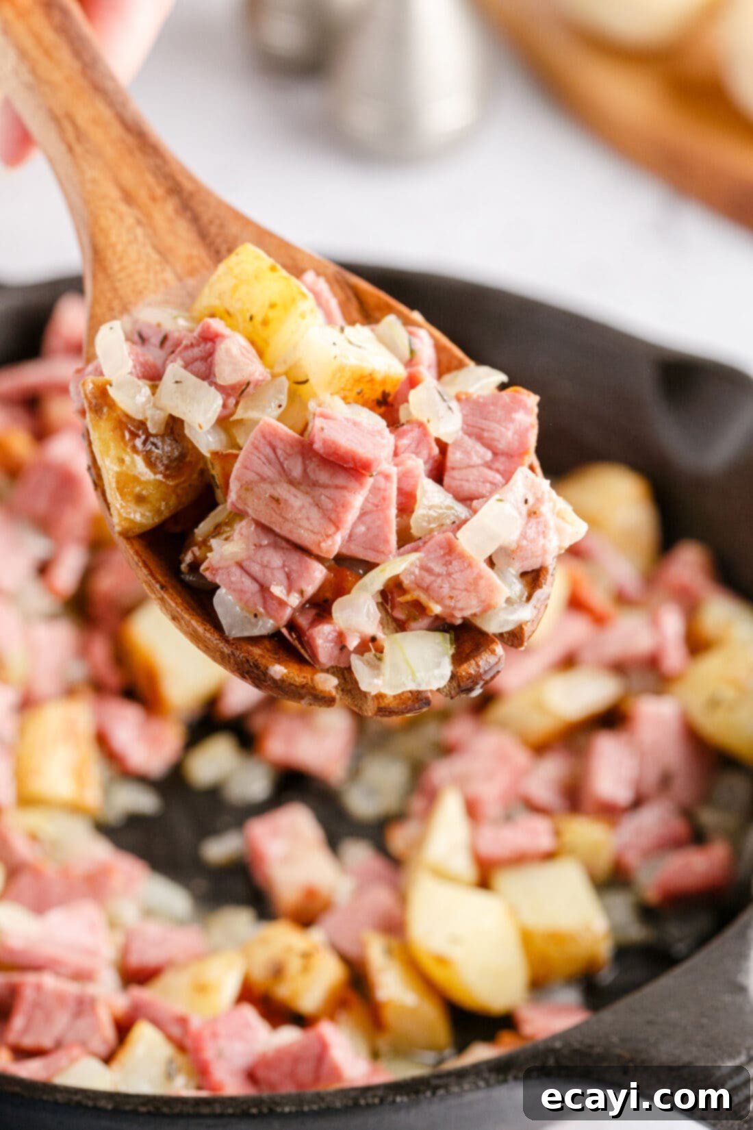Crispy Corned Beef Hash 10 A spoonful of freshly made Corned Beef Hash, showcasing its delicious texture and ingredients