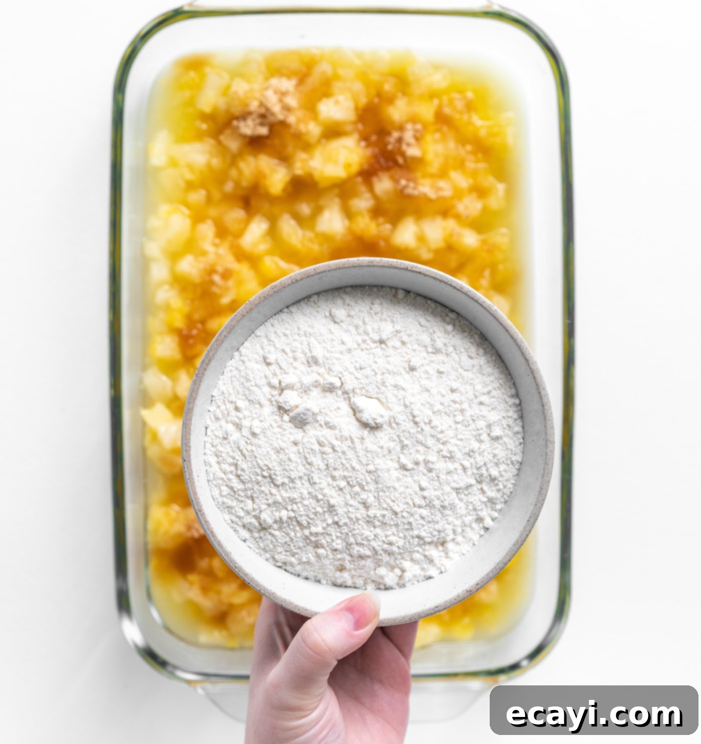 Easy Pineapple Cake 7 cake mix over crushed pineapple in a dish