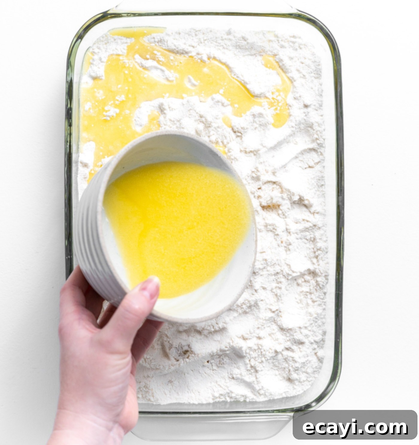 Easy Pineapple Cake 8 pouring melted butter over dump cake