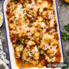 Hearty Sausage and Potato Bake 12 Sausage and Potato Casserole with a spoon in it