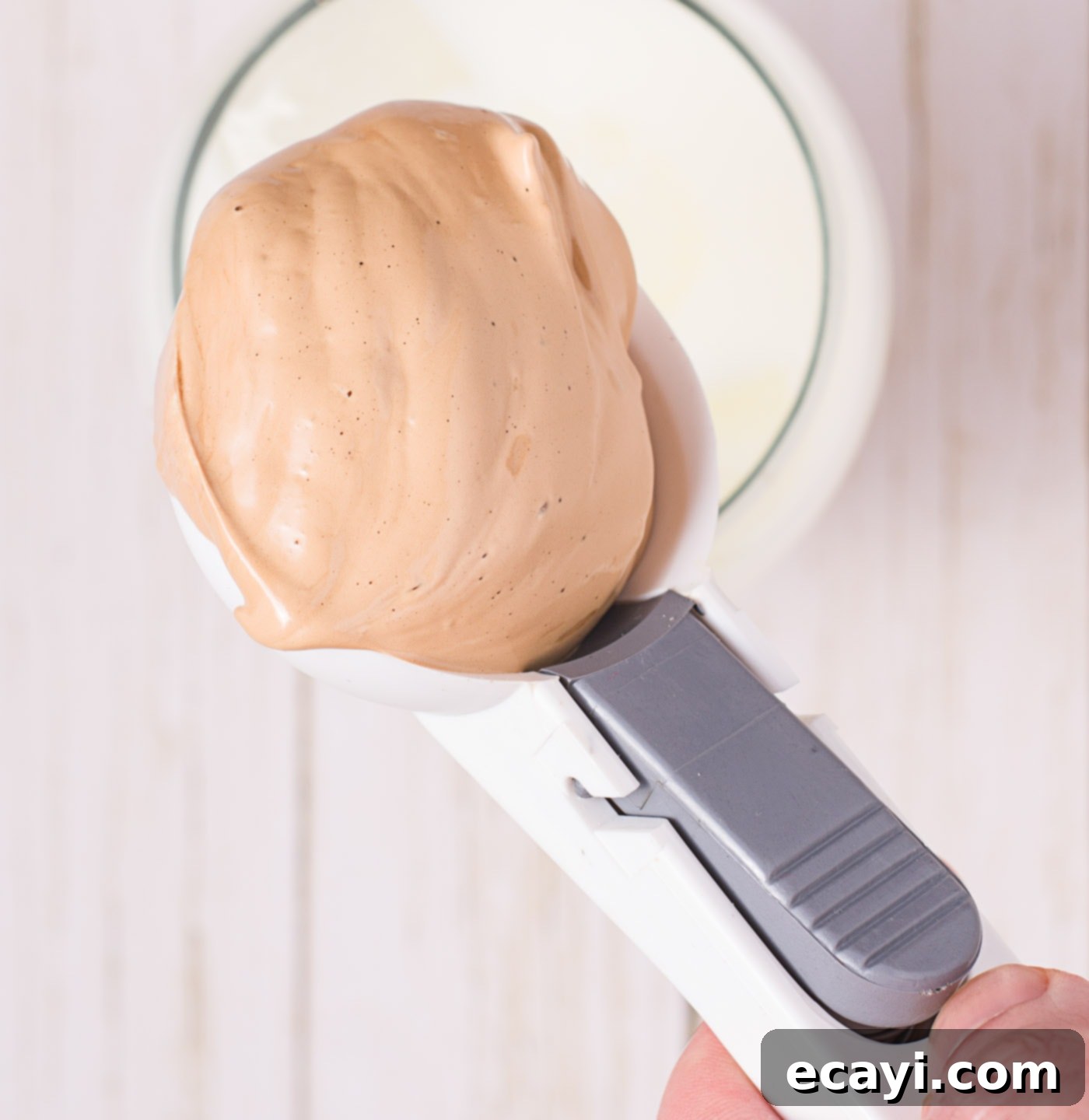 Whipped Coffee Sensation 7 scooping dalgona coffee into milk