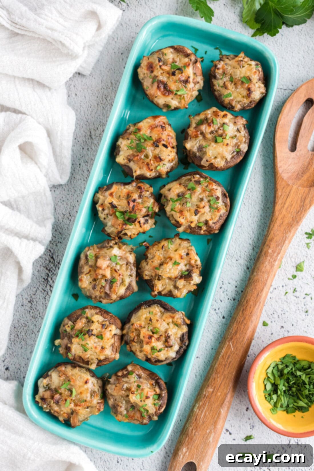 Gourmet Mushroom Poppers 2 A vibrant platter of golden brown cheesy stuffed mushrooms, ready to be served as an appetizer.