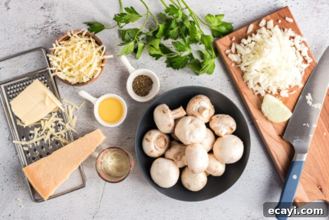 Gourmet Mushroom Poppers 4 A selection of fresh ingredients including mushrooms, onions, herbs, and various cheeses, laid out on a table.