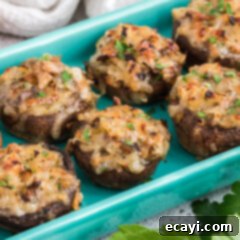 Gourmet Mushroom Poppers 10 Close-up of baked stuffed mushrooms with melted cheese topping.