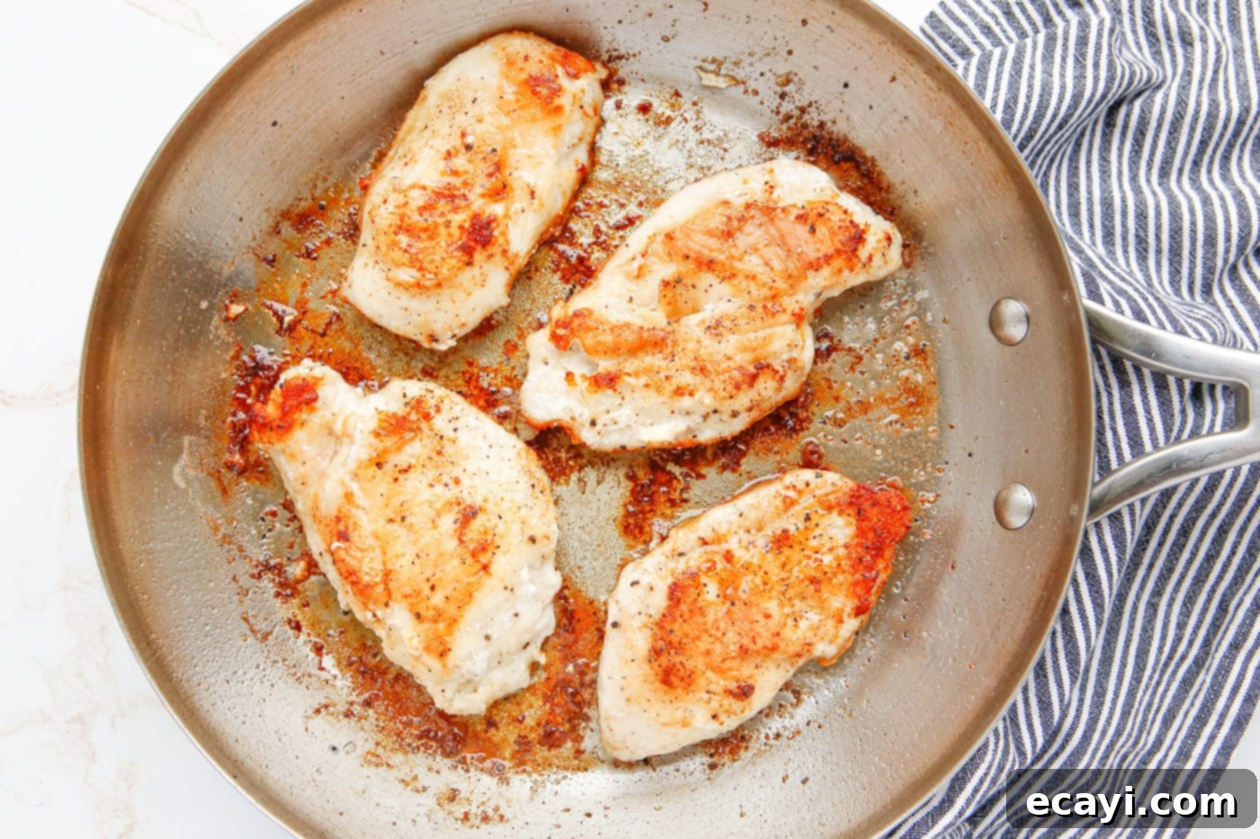 Savory Chicken Marsala 6 Pan-fried chicken breasts in a skillet, golden brown and cooked