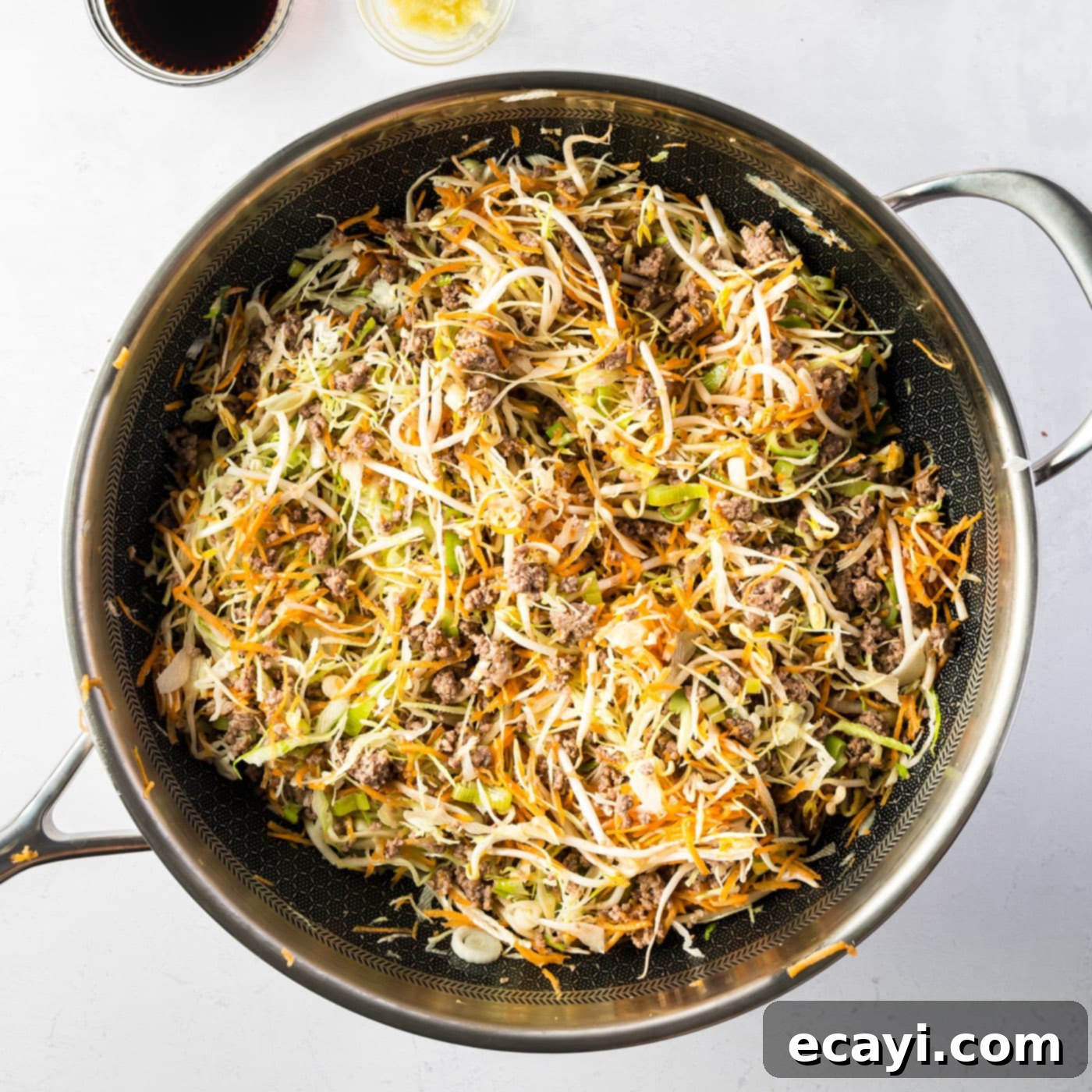 Egg Roll Stir-Fry Bowl 7 Egg roll in a bowl mixture cooking in a skillet, vegetables tenderizing
