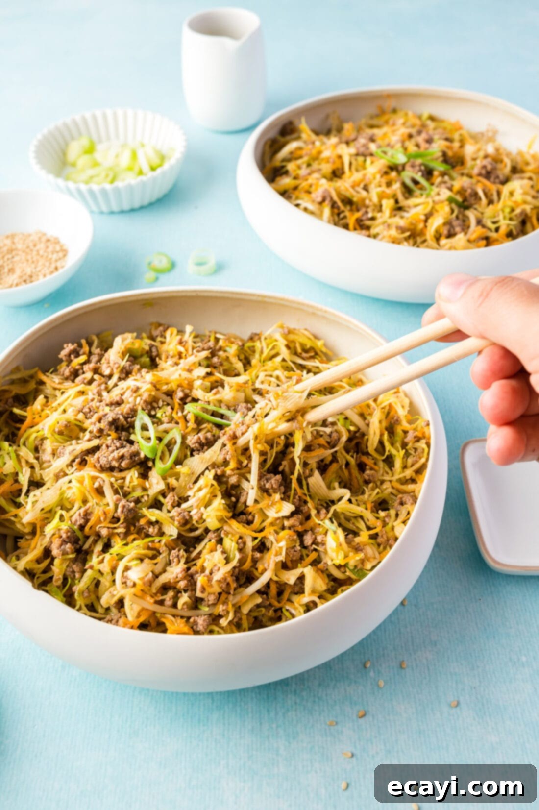 Egg Roll Stir-Fry Bowl 9 Chopsticks poised over a bowl of healthy Egg Roll in a Bowl, ready to be enjoyed