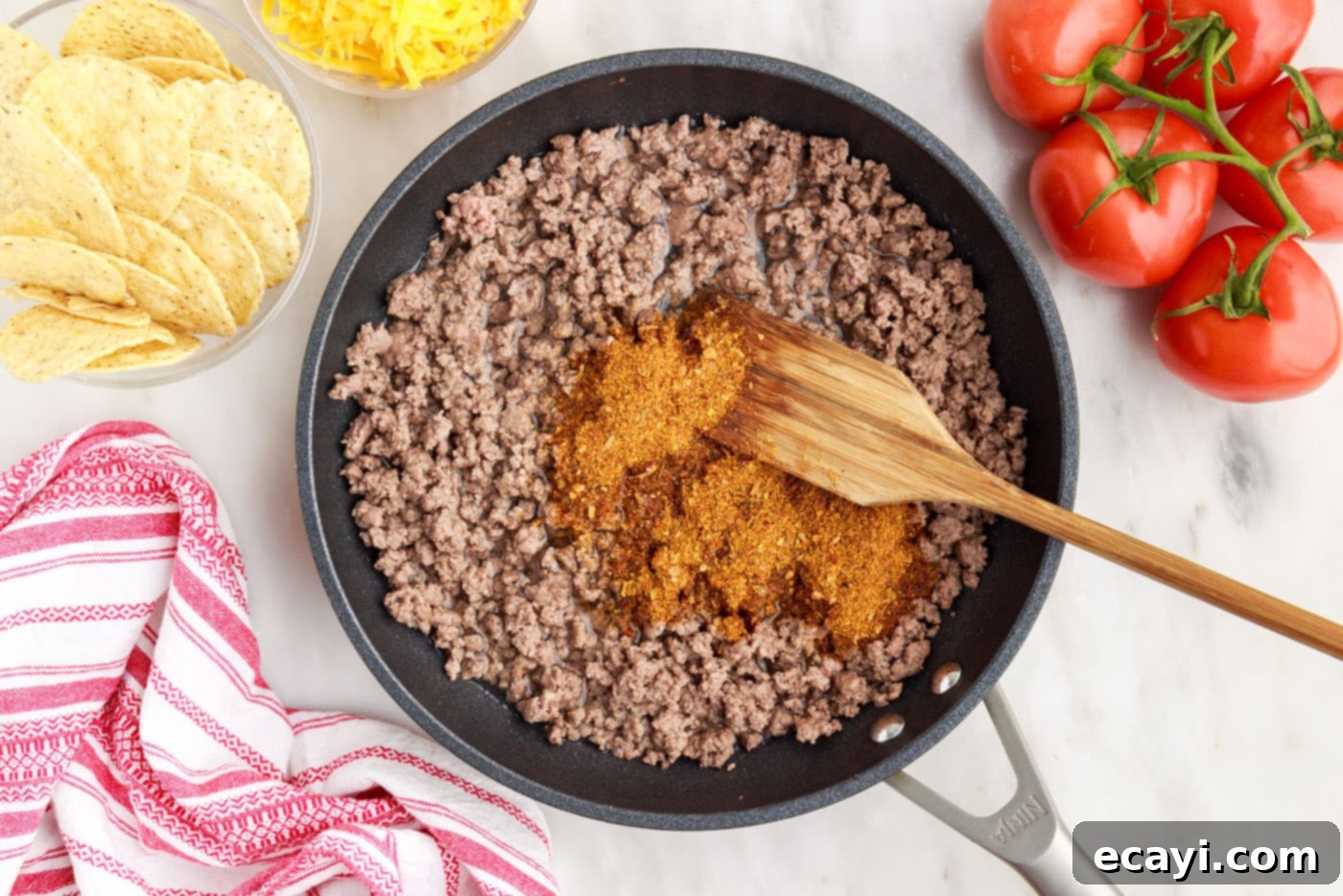 Ultimate Taco Casserole 5 browning ground beef in skillet with taco seasoning