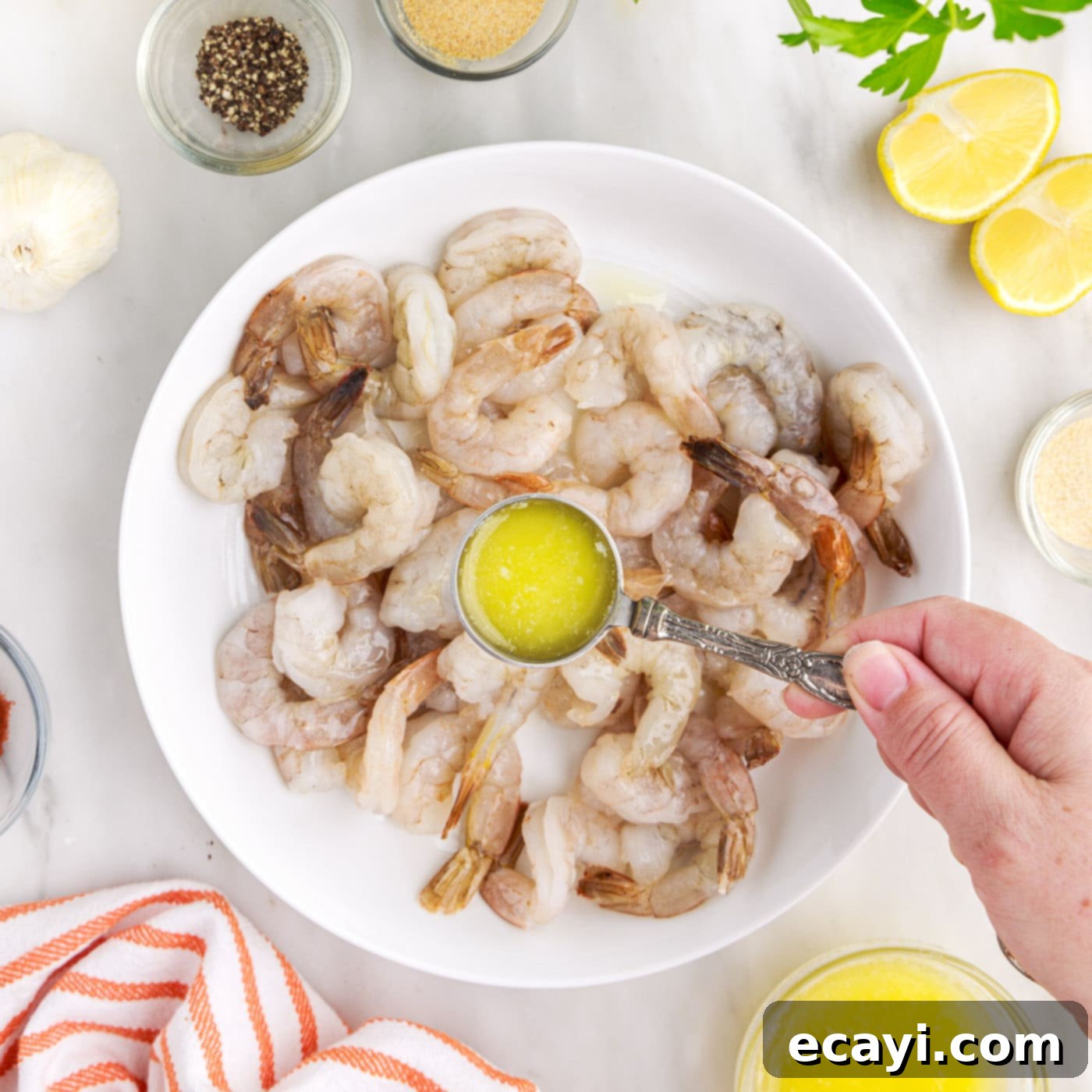 Crispy Air Fryer Shrimp 6 pouring melted butter over shrimp