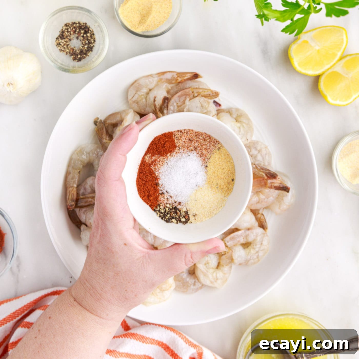 Crispy Air Fryer Shrimp 7 sprinkling seasonings over shrimp