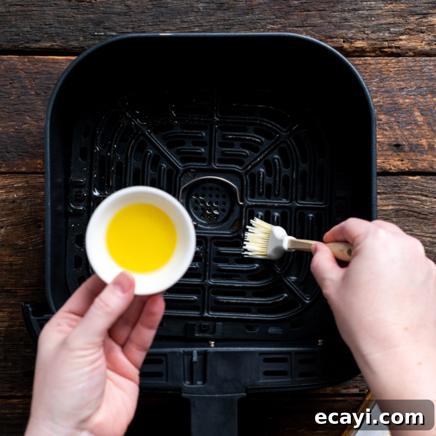 Effortless Air Fryer Fish Perfection 10 brushing air fryer with olive oil